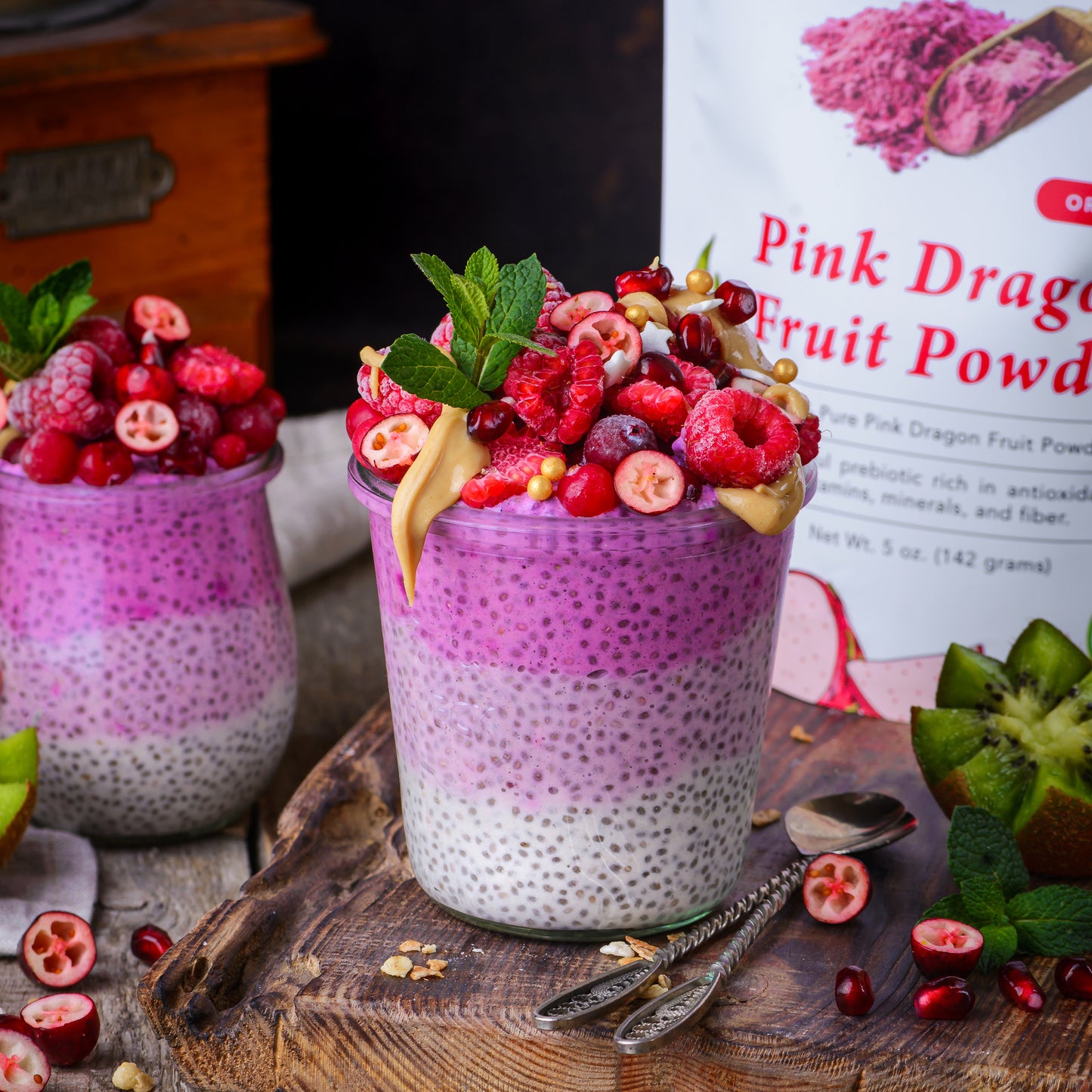Pink chia pudding made with Ancient Choice Dragon Fruit Powder, topped with berries, nut butter and mint.