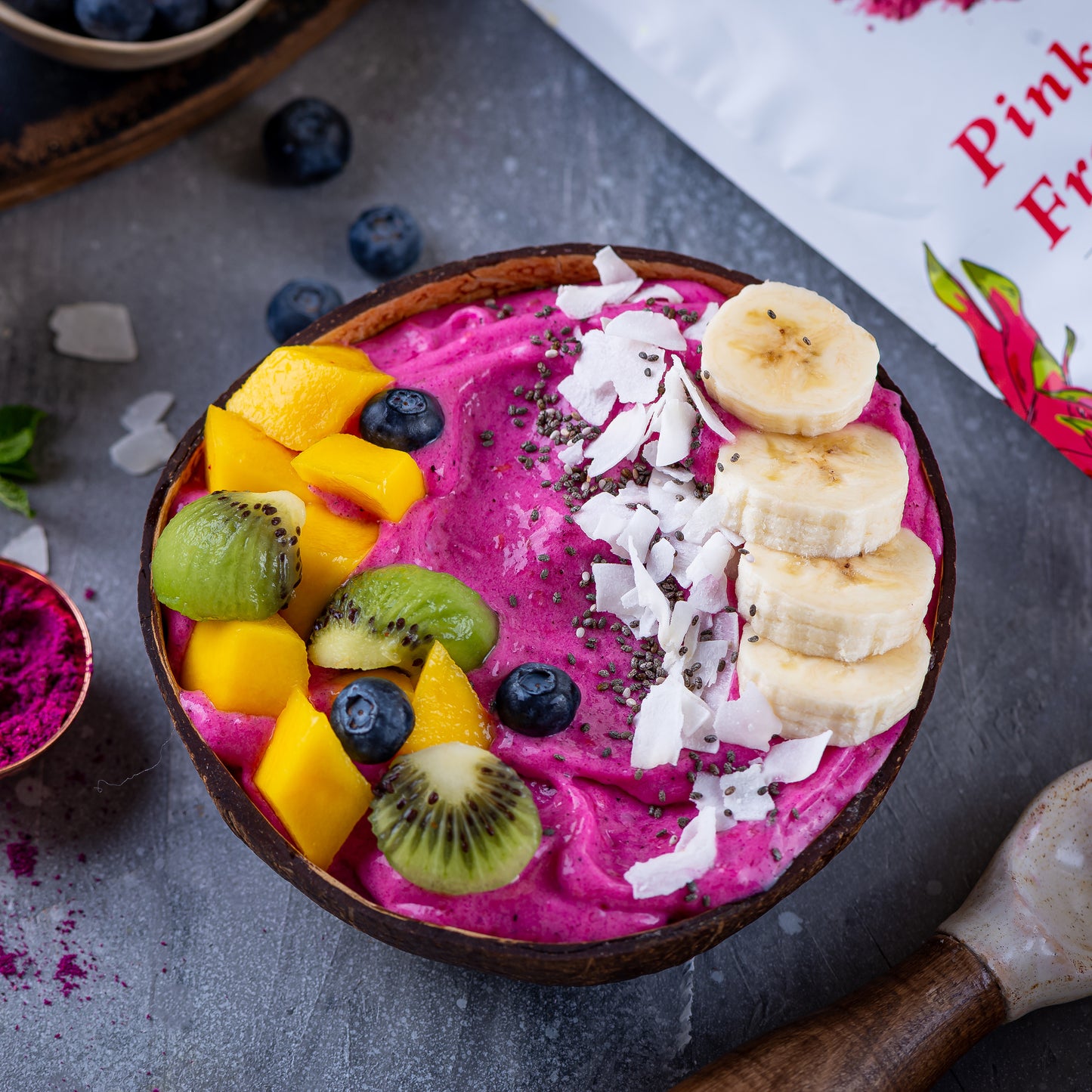 Smoothie bowl made with Ancient Choice Dragon Fruit Powder, topped with banana, coconut, and fresh fruits.