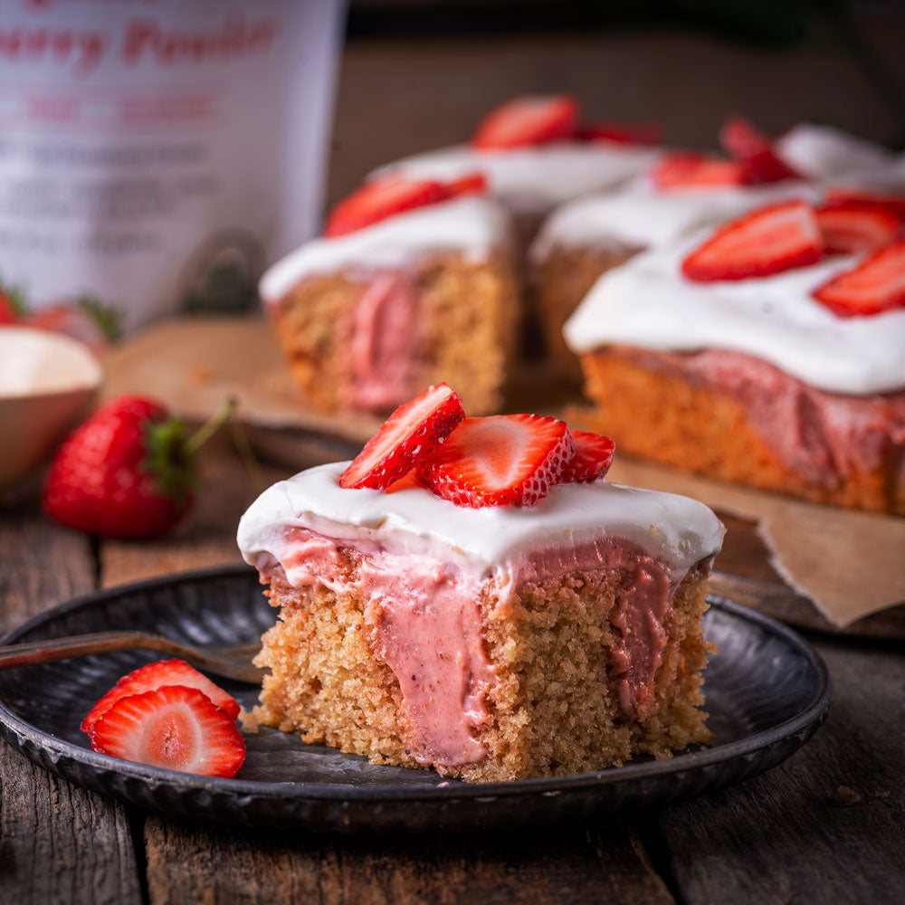 Strawberry cake made withAncient Choice Strawberry Powder, topped with whipped cream and fresh strawberries.